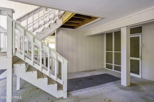 stairs with concrete flooring