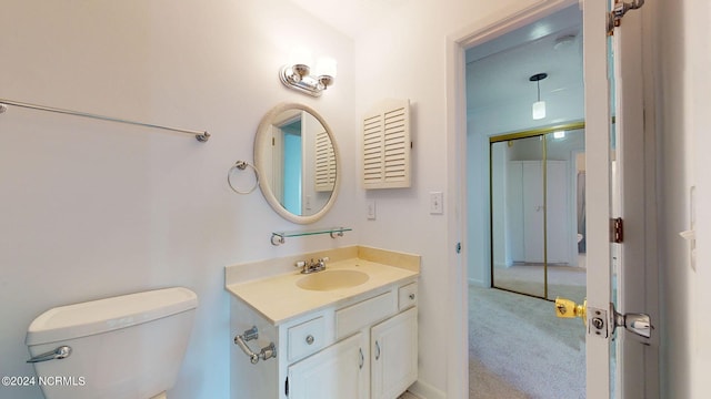 bathroom featuring toilet and vanity