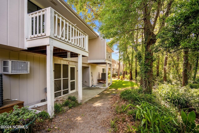 view of side of property featuring central AC unit and a patio