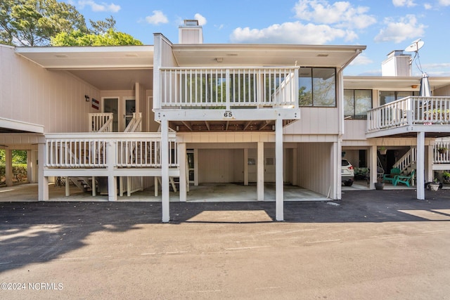 rear view of property with a carport