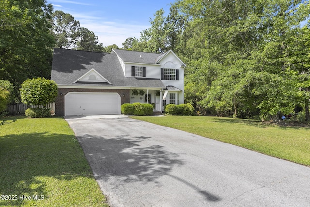 view of front facade with aphalt driveway, fence, brick siding, a garage, and a front yard