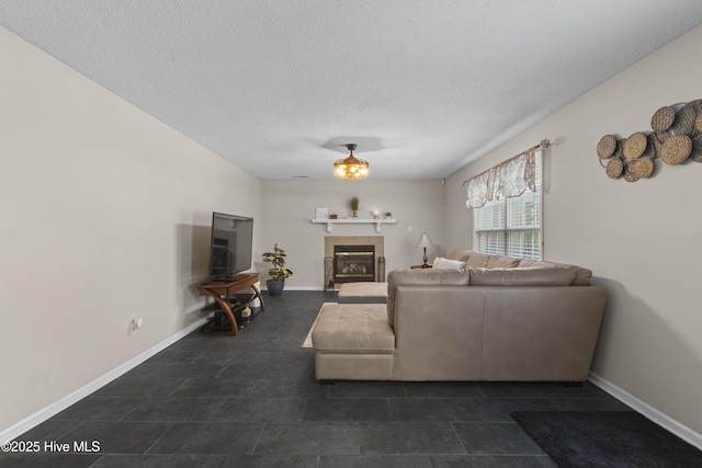 167 Dockside Dr, Jacksonville, NC 28546 - living room with baseboards, a fireplace, a textured ceiling, and dark tile patterned flooring