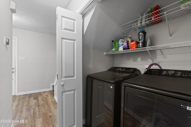 167 Dockside Dr, Jacksonville, NC 28546 - laundry area with separate washer and dryer, wood finished floors, a textured ceiling, and baseboards