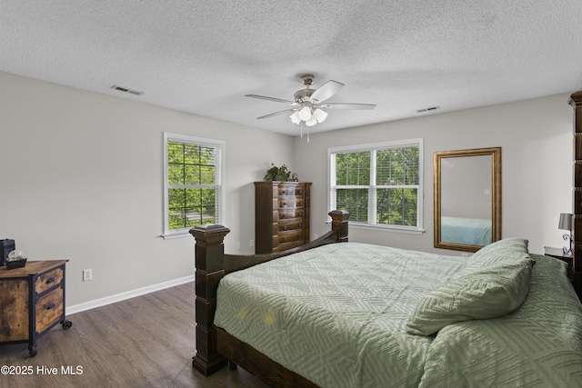 167 Dockside Dr, Jacksonville, NC 28546 - bedroom with wood finished floors, baseboards, a textured ceiling, and a ceiling fan
