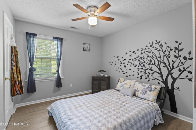 167 Dockside Dr, Jacksonville, NC 28546 - bedroom featuring wood finished floors, a textured ceiling, ceiling fan, and baseboards