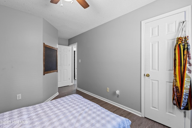 167 Dockside Dr, Jacksonville, NC 28546 - bedroom featuring dark wood finished floors, a textured ceiling, baseboards, and ceiling fan