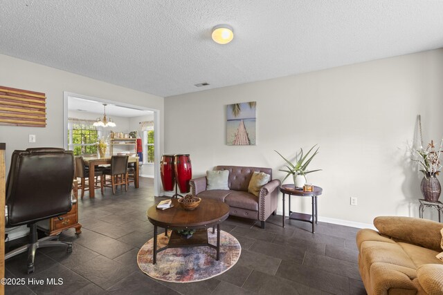 167 Dockside Dr, Jacksonville, NC 28546 - living area featuring a chandelier, baseboards, and a textured ceiling