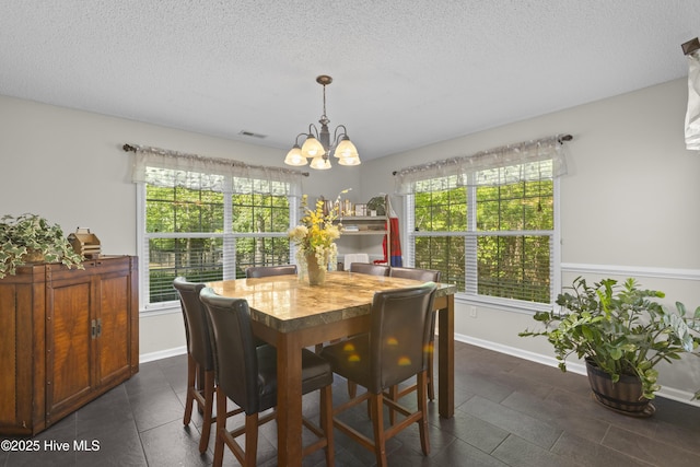 167 Dockside Dr, Jacksonville, NC 28546 - dining area featuring a chandelier, a textured ceiling, and baseboards
