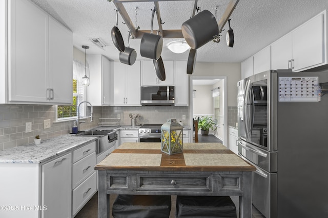167 Dockside Dr, Jacksonville, NC 28546 - kitchen with appliances with stainless steel finishes, a sink, white cabinetry, and a textured ceiling