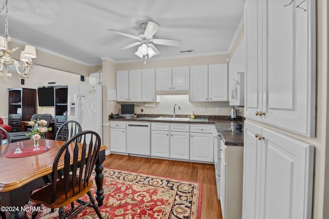 kitchen featuring crown molding, light hardwood / wood-style flooring, white cabinets, and white appliances