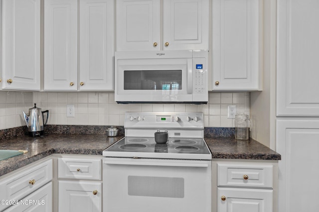 kitchen with white appliances, tasteful backsplash, and white cabinetry