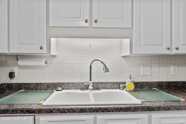 kitchen with sink and white cabinetry