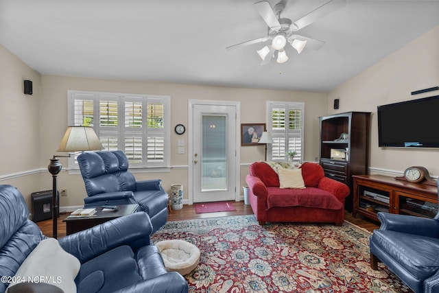 living room with wood-type flooring, ceiling fan, and lofted ceiling