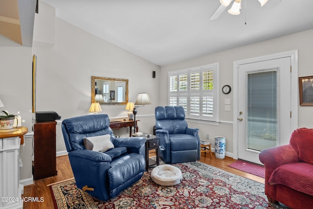 living room featuring vaulted ceiling, ceiling fan, and hardwood / wood-style floors