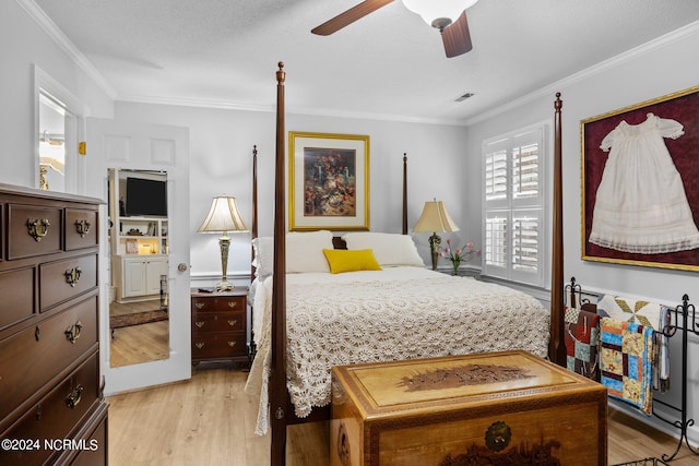 bedroom with crown molding, light hardwood / wood-style flooring, ceiling fan, and a textured ceiling