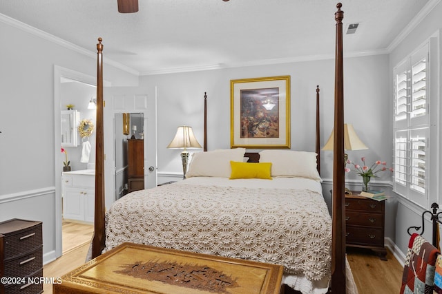 bedroom featuring ornamental molding, light hardwood / wood-style flooring, connected bathroom, and ceiling fan