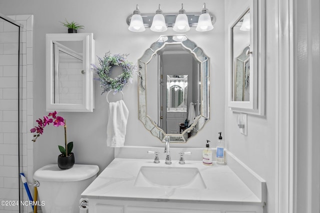 bathroom with vanity with extensive cabinet space and toilet