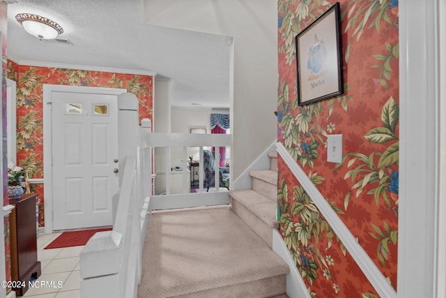 entrance foyer featuring tile floors and a textured ceiling