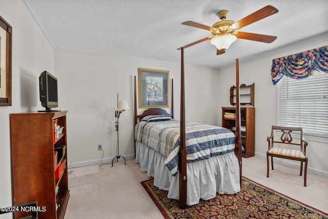 bedroom with ornamental molding, carpet, ceiling fan, and a textured ceiling