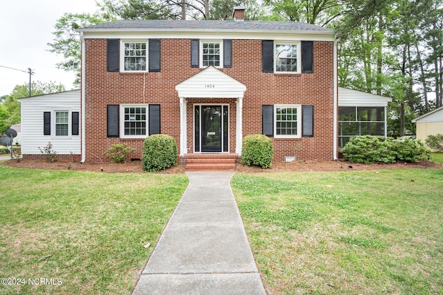 colonial inspired home with a front yard