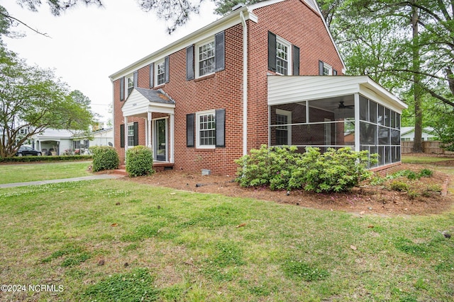 view of front of home with a sunroom and a front yard