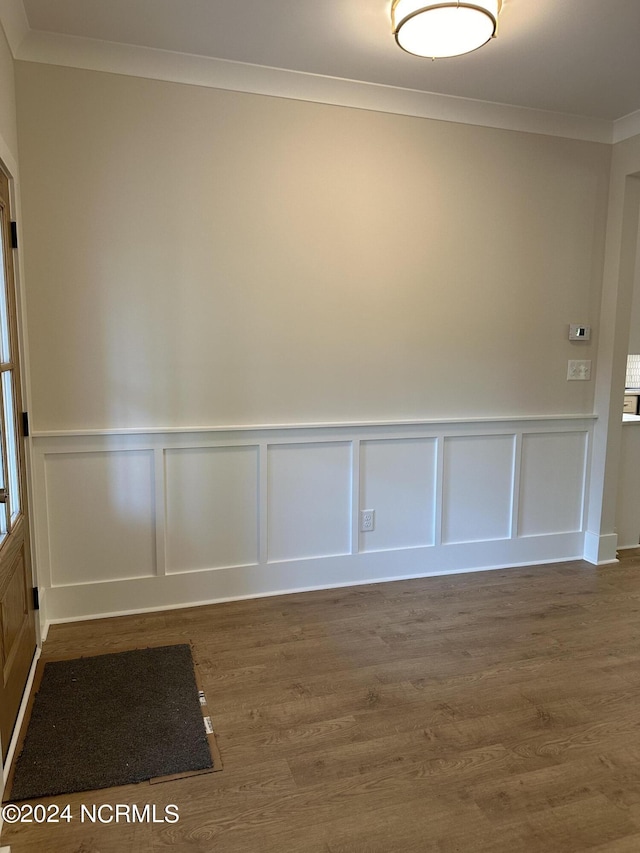 interior space featuring crown molding and wood finished floors