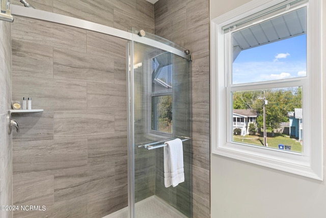 bathroom with a shower with door