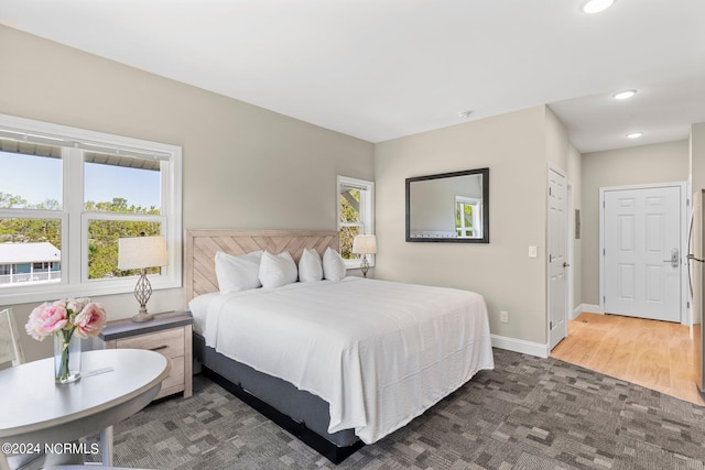 bedroom with hardwood / wood-style floors and a closet