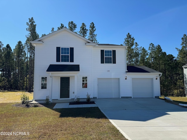 view of front of house featuring a front yard and a garage