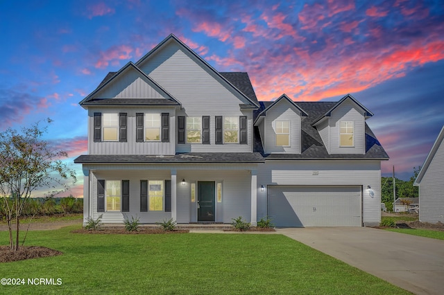 view of front of home featuring a yard and a garage