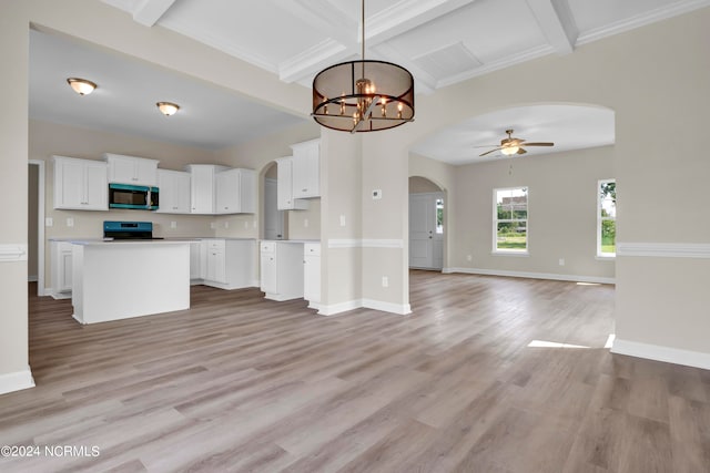 kitchen featuring light hardwood / wood-style floors, white cabinetry, beam ceiling, and black range oven