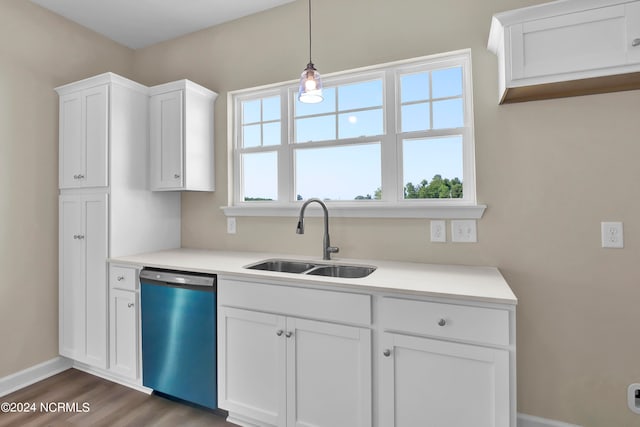 kitchen with hanging light fixtures, white cabinetry, dishwasher, dark hardwood / wood-style floors, and sink