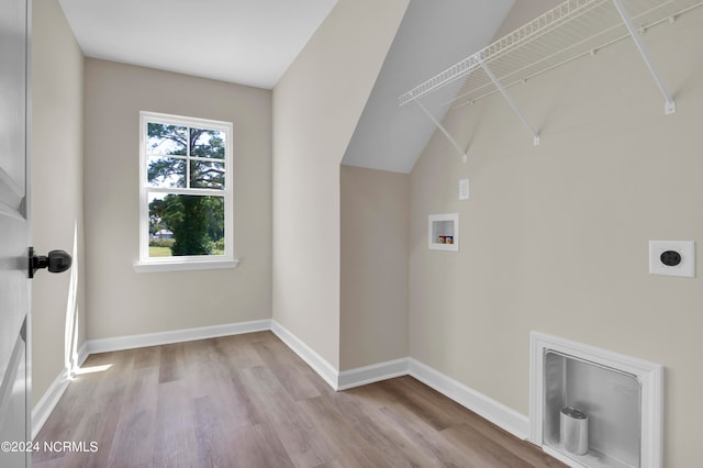 washroom featuring hookup for an electric dryer, light hardwood / wood-style flooring, and hookup for a washing machine