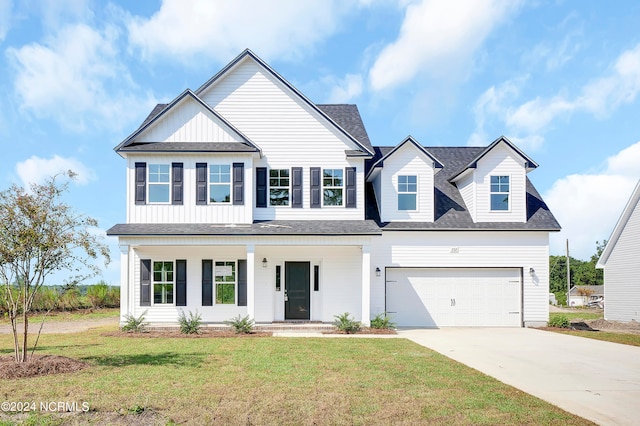 view of front of property with a front lawn and a garage