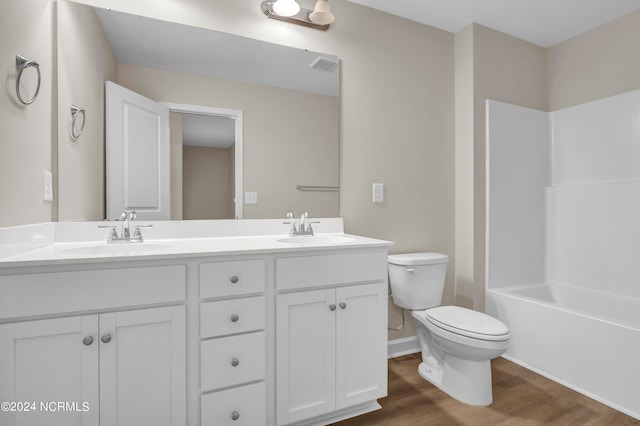 full bathroom featuring vanity, hardwood / wood-style floors, shower / washtub combination, and toilet