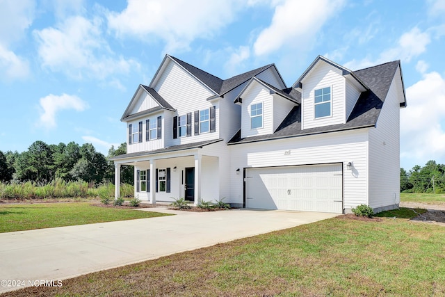 view of front of house with a garage and a front lawn