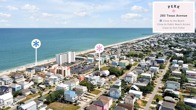 drone / aerial view with a water view and a beach view