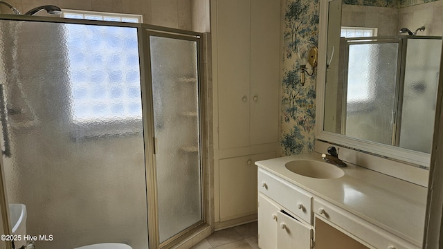 full bath with wallpapered walls, toilet, tile patterned floors, vanity, and a shower stall