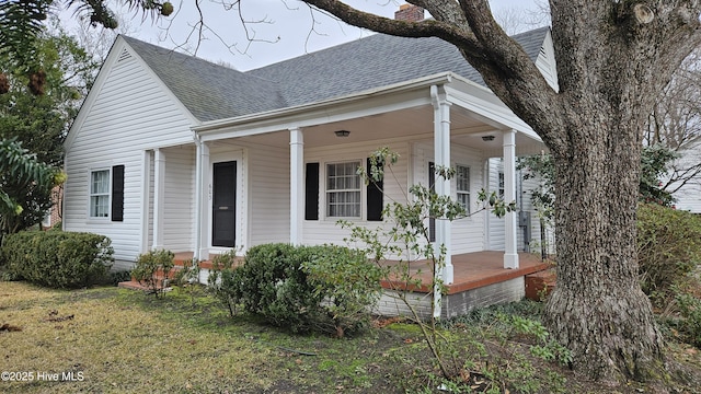 view of front of house with a front yard and a porch