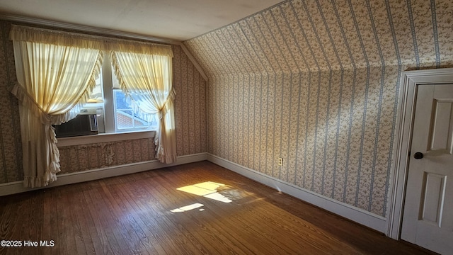 bonus room with baseboards, cooling unit, hardwood / wood-style flooring, and wallpapered walls