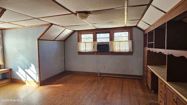 additional living space with lofted ceiling and wood finished floors