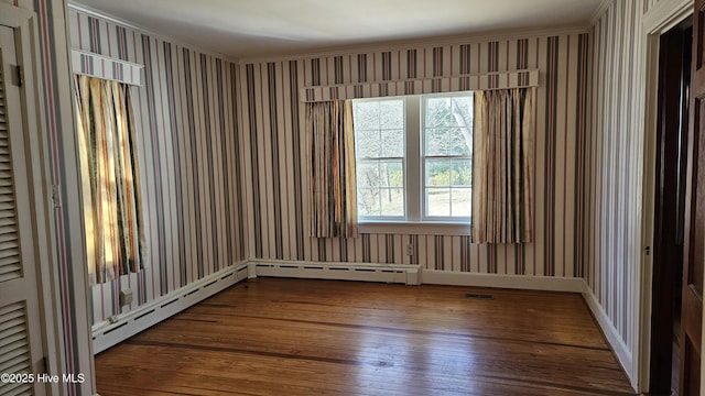 spare room featuring visible vents and hardwood / wood-style floors