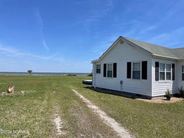 back of property with a deck and a yard