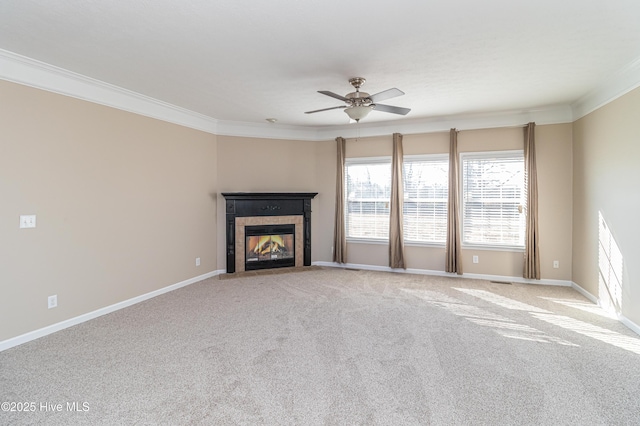 unfurnished living room featuring a fireplace, light colored carpet, ceiling fan, and crown molding