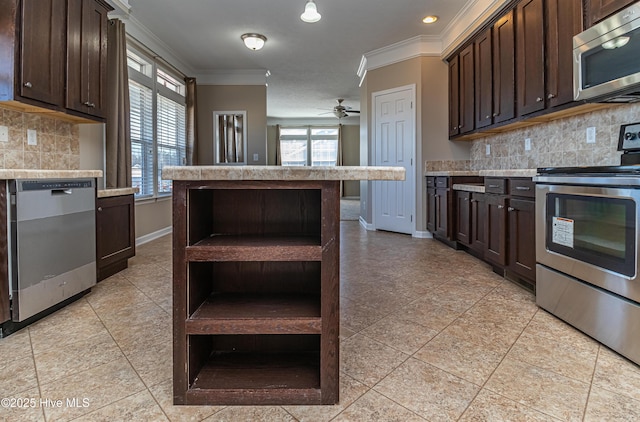 kitchen featuring dark brown cabinetry, ceiling fan, stainless steel appliances, tasteful backsplash, and crown molding