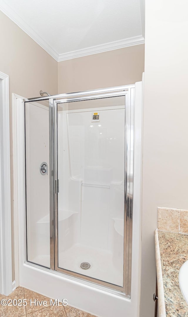 bathroom with walk in shower, tile patterned flooring, vanity, and ornamental molding