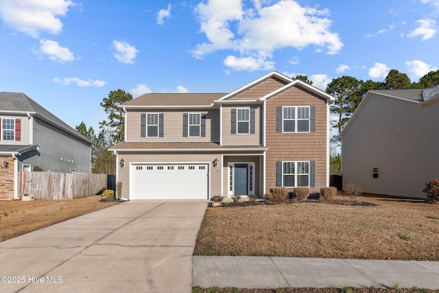 view of front of property with a garage and a front yard