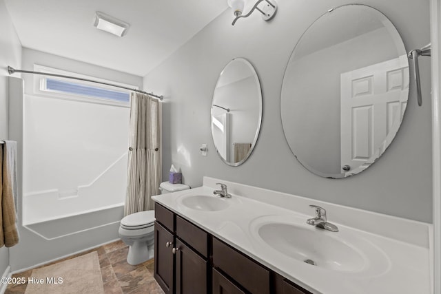 full bathroom featuring shower / tub combo with curtain, vanity, and toilet