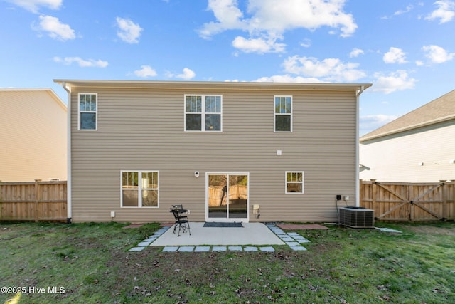 back of property featuring central AC, a patio area, and a lawn