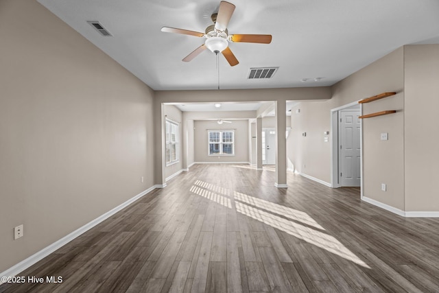 unfurnished living room featuring ceiling fan and dark hardwood / wood-style floors